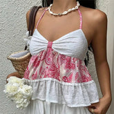 Woman wearing a pink and white patterned dress with a plain background